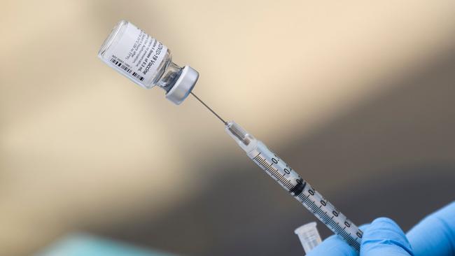 A nurse administers a shot of the Covid vaccine