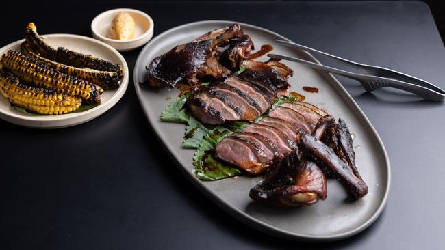 The $108 whole smoked duck with charred corn. Picture: David Kelly