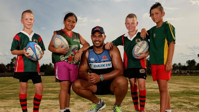 Bidwill product Senio Toleafoa of the Waratahs visits with Western Raptors Junior Rugby Union club players Jai Parkes, 10, Faith Manu, 10, Brayden Parkes, 10 and Ezekiel Oto, 11, at a rugby clinic held by the Waratahs at Mittigar reserve in Hassall Grove. Picture: Justin Sanson