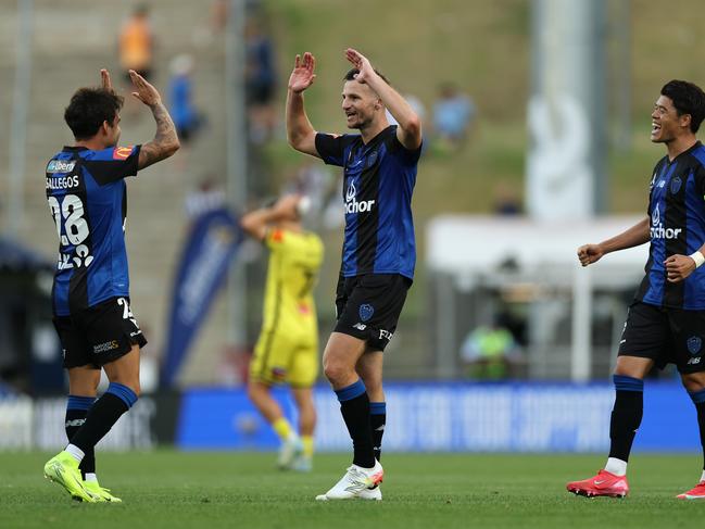 AUCKLAND, NEW ZEALAND - FEBRUARY 22: Felipe Gallegos, Tommy Smith and Hiroki Sakai celebrate following the round 20 A-League Men match between Auckland FC and Wellington Phoenix at Go Media Stadium, on February 22, 2025, in Auckland, New Zealand. (Photo by Phil Walter/Getty Images)