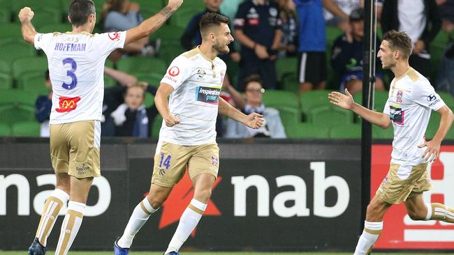 Kaine Sheppard of the Jets, centre, celebrates a goal with teammates against the Melbourne Victory. Picture: AAP