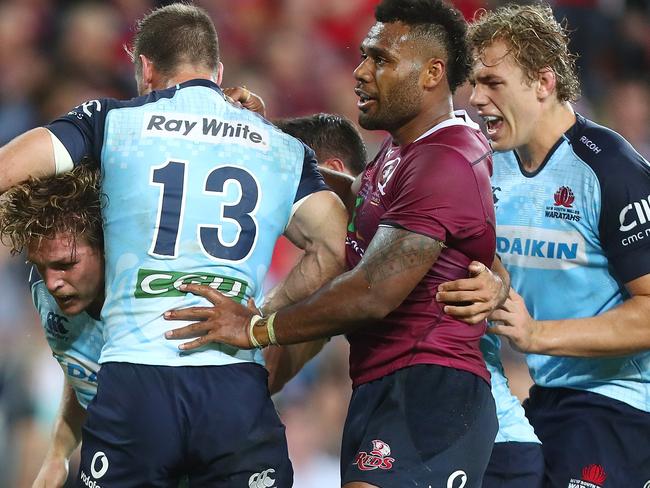 Waratahs players celebrate a try from captain Michael Hooper (left)