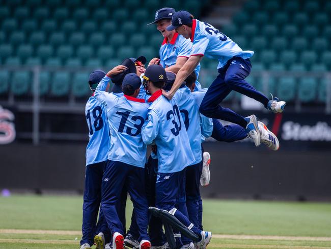 NSW Metro players celebrate taking the match sealing wicket against Queensland in the under-17 national cricket championships final at Launceston on Thursday. Picture: Linda Higginson/Cricket Australia (EDITORIAL USE ONLY)