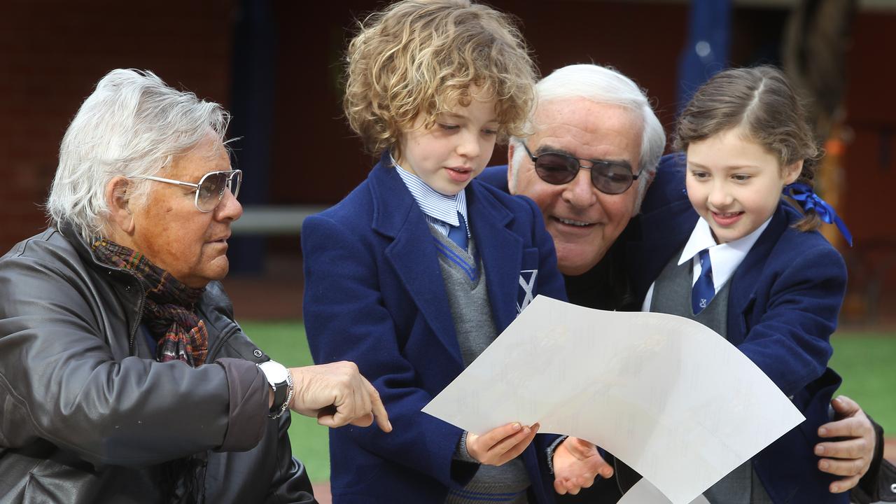 Harry and George at St Andrew's Primary School with students Monty Callen, 8, and Ciara Trimboli, 7 checking out their designs for a new school uniform.