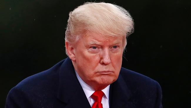 TOPSHOT - US President Donald Trump looks on as he visits the American Cemetery of Suresnes, outside Paris, on November 11, 2018 as part of Veterans Day and the commemorations marking the 100th anniversary of the 11 November 1918 armistice, ending World War I. (Photo by CHRISTIAN HARTMANN / POOL / AFP)