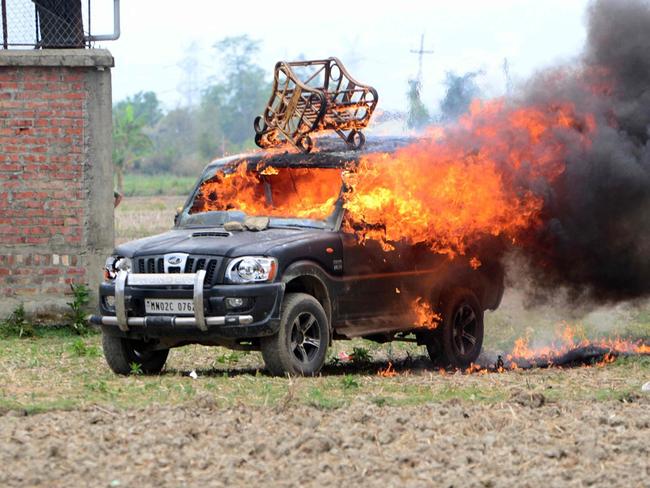 In this picture taken on May 4, 2023, smoke billows from a vehicle allegedly burned by the Meitei community tribals protesting to demand inclusion under the Scheduled Tribe category, in Imphal the capital of India's Manipur state. (Photo by AFP)