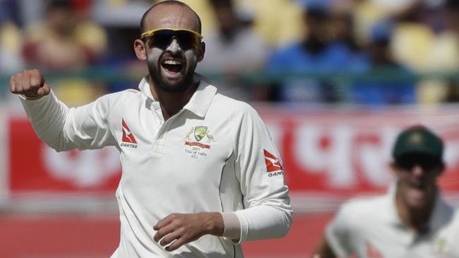 Australia's Nathan Lyon celebrates the dismissal of India's Cheteshwar Pujara.