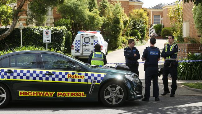 Police guard the block of units on Mitcham road in Mitcham after the stabbing. Picture: Stuart Milligan