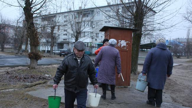 Residents collect water from a well in the town of Schastia, near the eastern Ukraine city of Lugansk, on February 23, 2022, after the town's pump stations were knocked out of power by shelling. Picture: AFP