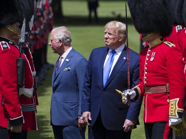 Prince Charles, left, talks with a member of the Guard of Honour, as Captain of the Guard Hamish Hardy, right, walks with President Donald Trump. Picture: AP