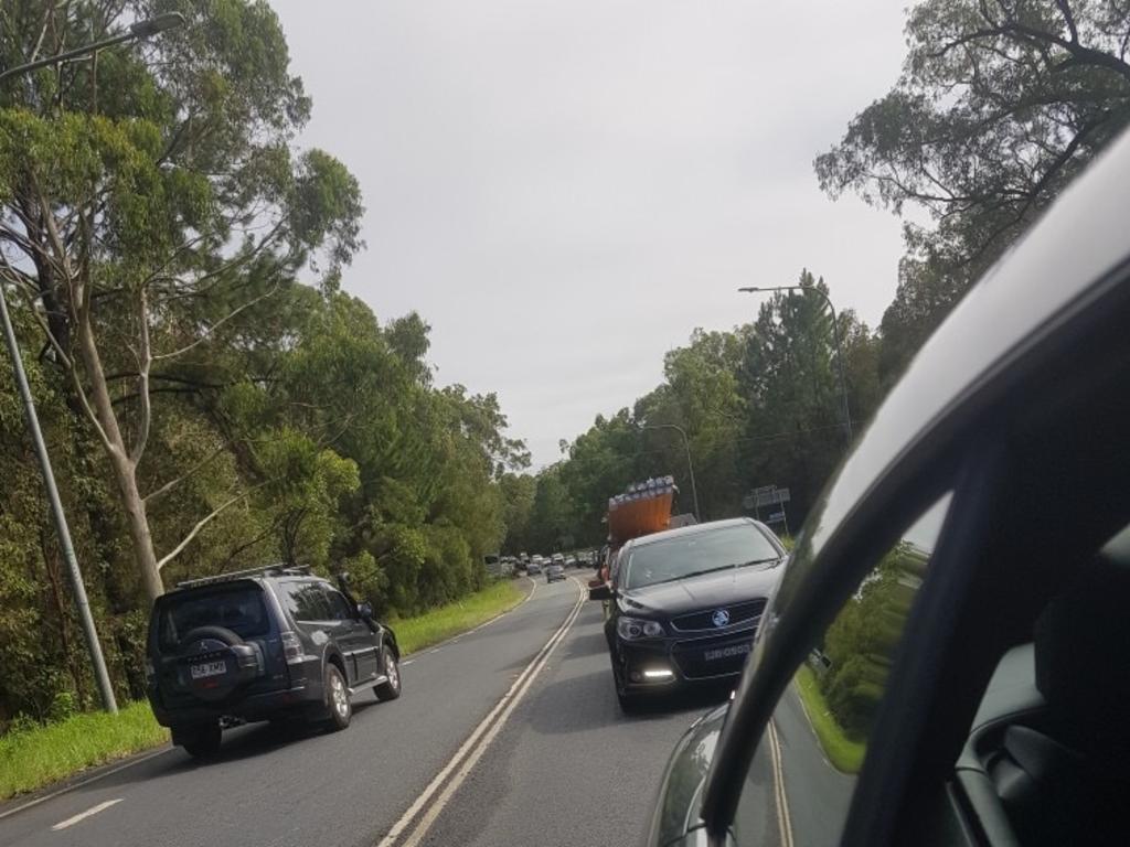 Cars stopped on Sunshine Coast roads due to flooding.