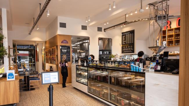 The coffee beans are carried through a tube on the ceiling into the coffee machine. Picture: David Kelly