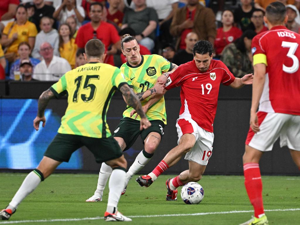 Indonesia's Thom Haye vies for the ball with Australia's Jackson Irvine. Picture: AFP