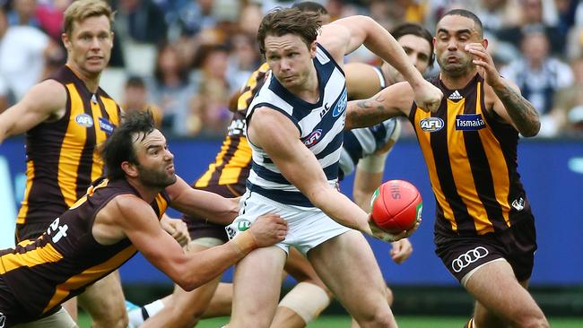 AFL: Round 1 Geelong V Hawthorn at MCG 28th March, Melbourne Australia. Geelong's Patrick Dangerfield takes on Hawthorn's Jordan Lewis and Shaun Burgoyne Picture : George Salpigtidis