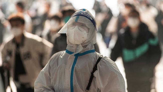 A passenger wearing PPE arriving at Hankou Railway Station in Wuhan in China's central Hubei province.