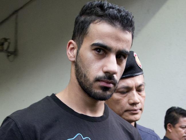 FILE - In this Tuesday, Dec. 11, 2018, file photo, prison guards escort Bahraini football player Hakeem al-Araibi from a court in Bangkok, Thailand. Thailand officially received a request from Bahrain to extradite a detained soccer player who has refugee status in Australia. The foreign ministry says the request for extraditing Hakeem al-Araibi has been forwarded to prosecutors for deliberation. (AP Photo/Gemunu Amarasinghe, File)