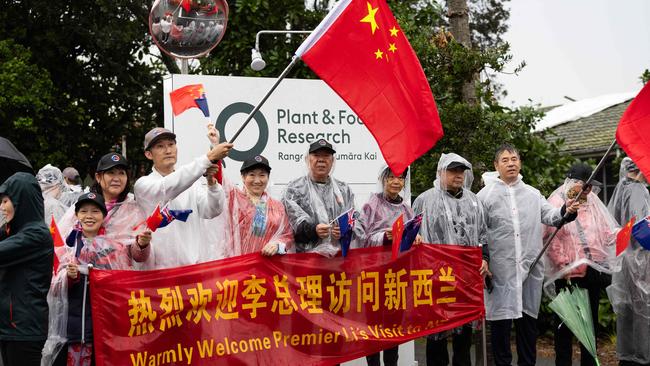 Supporters welcome Mr Li to Auckland. Picture: AFP