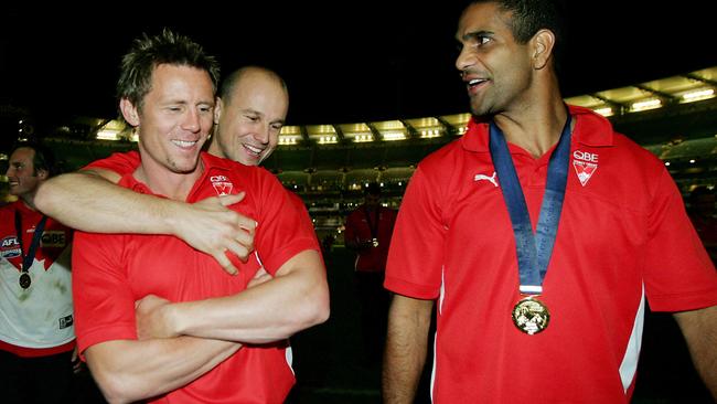 GOOD TEAMMATES: Matthew Nicks gives Swans teammate Stuart Maxfield a hug after the 2005 grand final as Michael O'Loughlin looks on. Nicks and Maxfield missed the win against West Coast through injury.