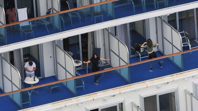 Passengers stuck on the Ruby Princess fill in their days on the balconies of the ship. Picture: Simon Bullard