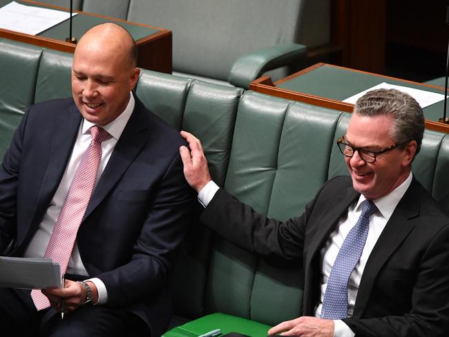 Defence Minister Christopher Pyne gives Home Affairs Minister Peter Dutton a reassuring pat on the back. Picture: AAP