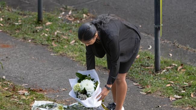 Mourners drop off flowers at the scene. Picture: Julian Andrews