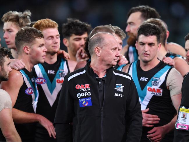 Ken Hinkley with players at the three-quarter time break during the Round 23 win against the Dockers at Adelaide Oval. Picture: AAP IMAGE/DAVID MARIUZ