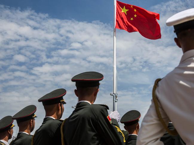 (FILES) This file photo taken on June 30, 2019 shows soldiers from the Peoples' Liberation Army (PLA) during a flag raising ceremony at an open day at the Ngong Shuen Chau Barracks in Hong Kong to mark the 22nd anniversary of Hong Kong's handover from Britain to China on July 1. - China will increase its military budget by 6.6 percent in 2020, the government announced on May 22, 2020 at the opening session of its annual National People's Congress in Beijing. (Photo by ISAAC LAWRENCE / AFP)