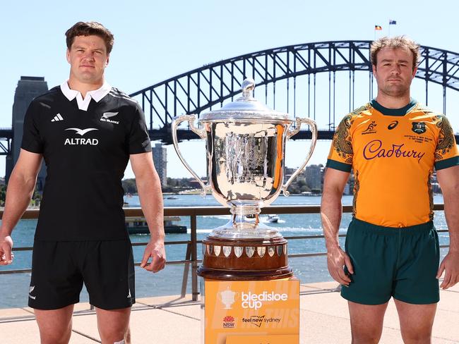 SYDNEY, AUSTRALIA - SEPTEMBER 20: All Blacks captain Scott Barrett and Wallabies captain Harry Wilson pose alongside the Bledisloe Cup during a media opportunity ahead of tomorrow night's Wallabies v All Black Bledisloe Cup match, at Sydney Opera House on September 20, 2024 in Sydney, Australia. (Photo by Jason McCawley/Getty Images)