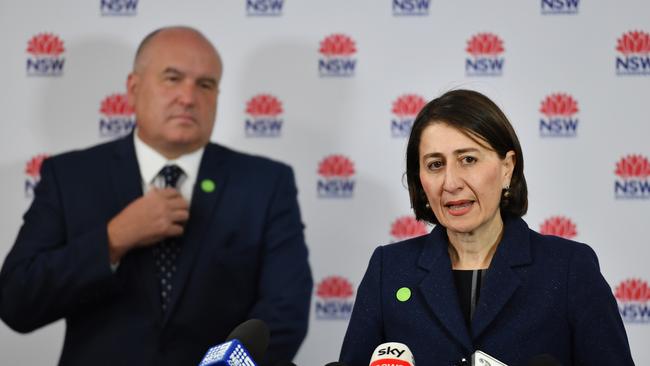 Gladys Berejiklian and the Minister for Police and Emergency Services David Elliott speak to the media. Picture: AAP.