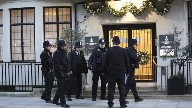 Police officers outside the main entrance of King Edward VII Hospital, where Prince Philip was treated. Picture: AP