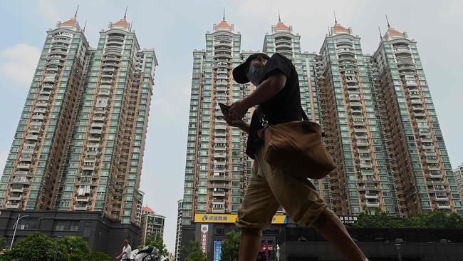 A man walks past a housing complex by Chinese property developer Evergrande in Guangzhou, China's southern Guangdong province. Picture: AFP