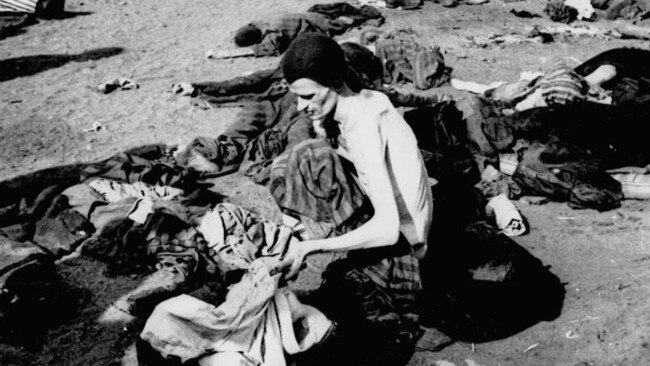 A survivor of the Bergen-Belsen concentration camp in Nazi Germany appears a living skeleton as he delouses his clothes at the camp in April 1945 soon after it was liberated by Allied troops. (AP Photo/Files)