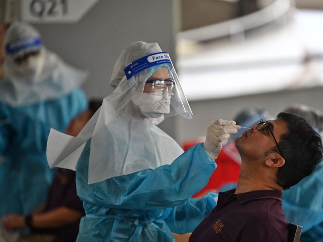 Employees have rapid antigen tests in Bangkok. Picture: AFP