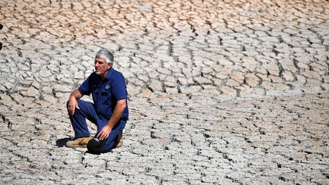 Orchard owner Dino Rizzato in a dried up dam at Cottonvale apple orchard, outside the drought ravaged town of Stanthorpe, 180km south west of Brisbane. Picture: Mick Tsikas