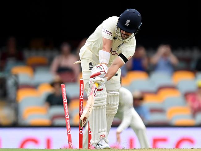 BRISBANE, AUSTRALIA - DECEMBER 08:  Rory Burns of England is clean bowled by  Mitchell Starc of Australia during day one of the First Test Match in the Ashes series between Australia and England at The Gabba on December 08, 2021 in Brisbane, Australia. (Photo by Bradley Kanaris/Getty Images)