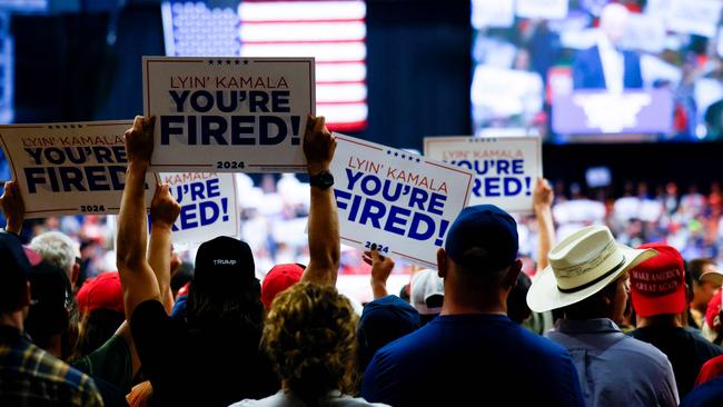 Supporters hold up signs at a Donald Trump rally. Picture: Getty Images via AFP.