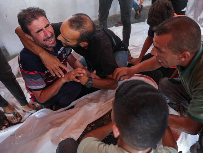 Family and friends mourn by the bodies of five members of the Alborno family at Al-Ahli Arab hospital, also known as the Baptist hospital in Gaza City. Picture: AFP