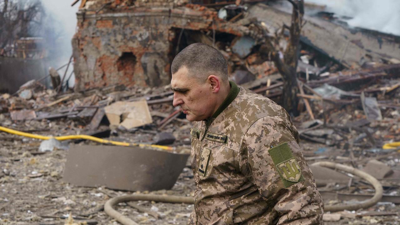 Ukraine, Ukrainian army public affairs officer Valentin Yermolenko walks in front of a destroyed shoe factory in Dnipro on March 11. Picture: Emre Caylak / AFP