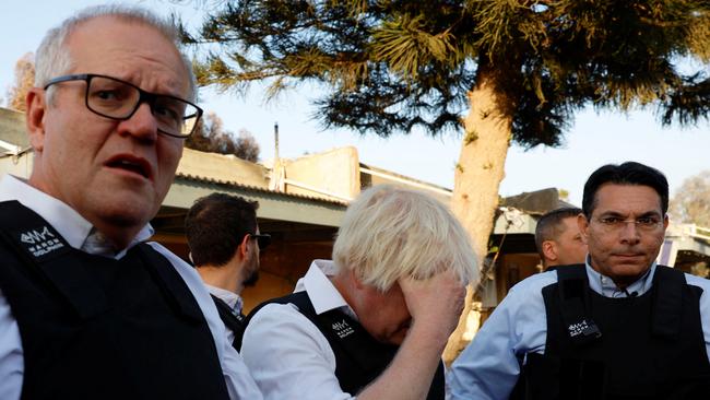 Scott Morrison and Boris Johnson at Kibbutz Kfar Aza with Danny Danon on Sunday. Picture: Reuters