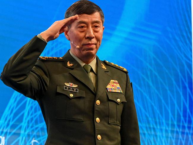 China's Minister of National Defence Li Shangfu salutes the audience before delivering a speech during the 20th Shangri-La Dialogue summit in Singapore on June 4, 2023. (Photo by Roslan RAHMAN / AFP)