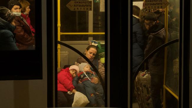 People evacuated from the Donetsk region sit in a bus waiting for their train to be evacuated deep into Russia, in the town of Taganrog on Sunday. Picture: AFP