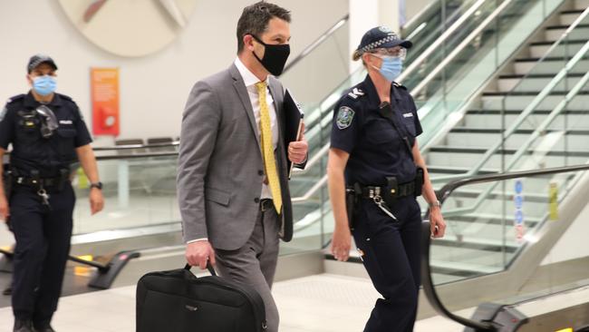 South Australian Senator Alex Antic escorted through Adelaide Airport by police on December 2. Picture: Dean Martin