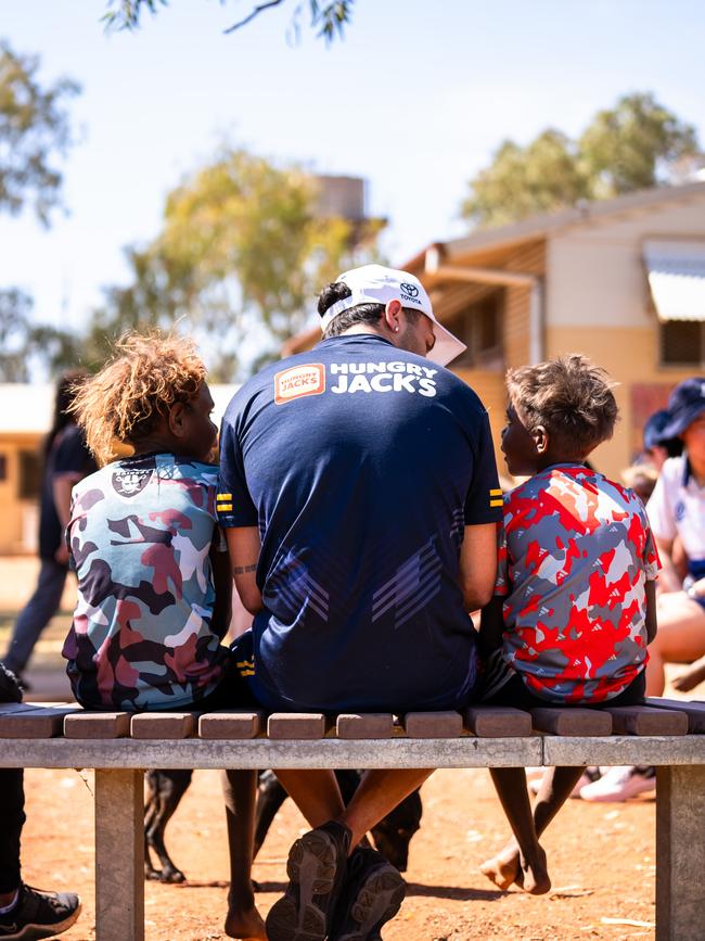 Izak Rankine with two children in the APY Lands. Picture: AFC