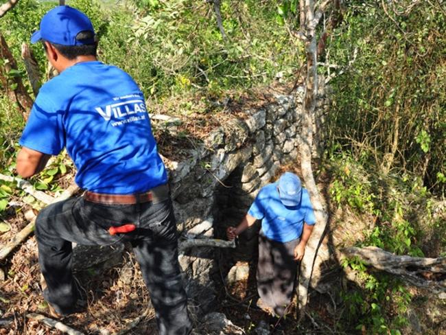 Hot work ... Archaeologist examine a separate site in the heavily jungled Central Americas. Source: Supplied