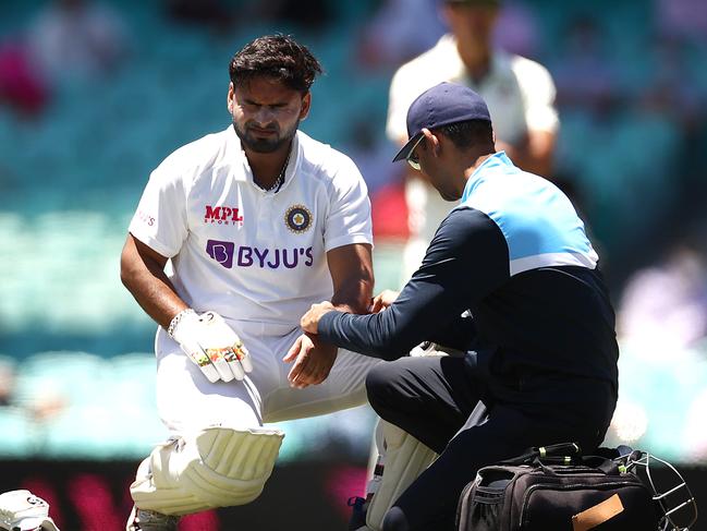 SYDNEY, AUSTRALIA - JANUARY 09: Rishabh Pant of India reacts after being struck by a delivery from Pat Cummins of Australia during day three of the 3rd Test match in the series between Australia and India at Sydney Cricket Ground on January 09, 2021 in Sydney, Australia. (Photo by Ryan Pierse/Getty Images)