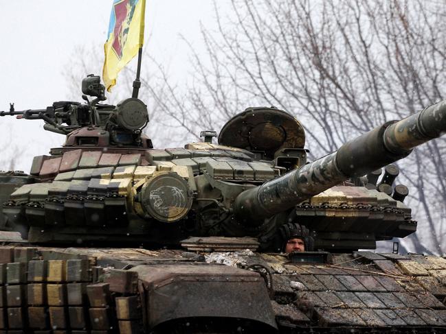 A serviceman of Ukrainian Military Forces looks out from his tank prior to the battle with Russian troops and Russia-backed separatists in Luhansk region on March 8. Picture: Anatolii Stepanov / AFP