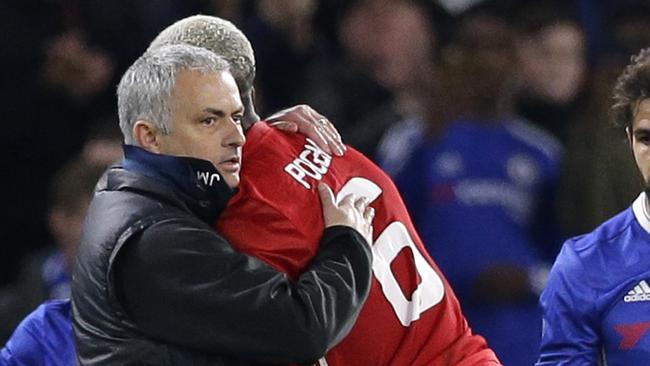 Manchester United's manager Jose Mourinho embraces his player Paul Pogba.
