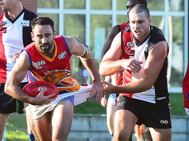 West Coburg’s Jack Yelland keeps a grip on Maribynong Park’s John McKenzie. 