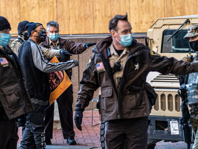 Hennepin County sheriffs arrest an activist outside the venue where the second day of jury selection begins at the trial of former Minneapolis Police officer Derek Chauvin. Picture: AFP