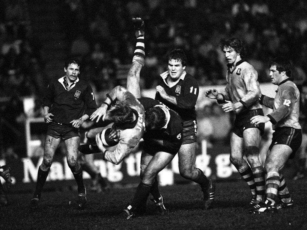 A Blues player is upended.